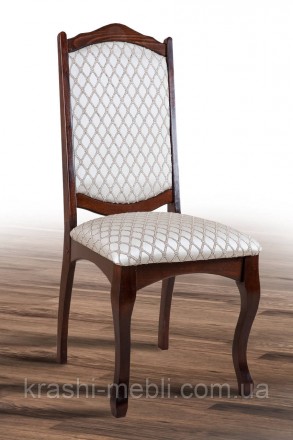 Дерев'яний обідній стілець із м'яким сидінням і спинкою, оббитими тканиною.
Габа. . фото 2