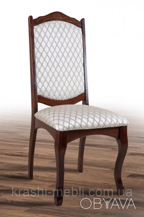 Дерев'яний обідній стілець із м'яким сидінням і спинкою, оббитими тканиною.
Габа. . фото 1