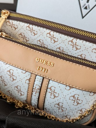 Жіноча сумка Guess ?Прикрашена фірмовим логотипом Guess
Цвет:
білий
- Фурнітура . . фото 4