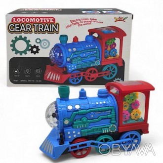 Яркая интерактивная игрушка в виде локомотива поезда. Внутри игрушки размещены р. . фото 1